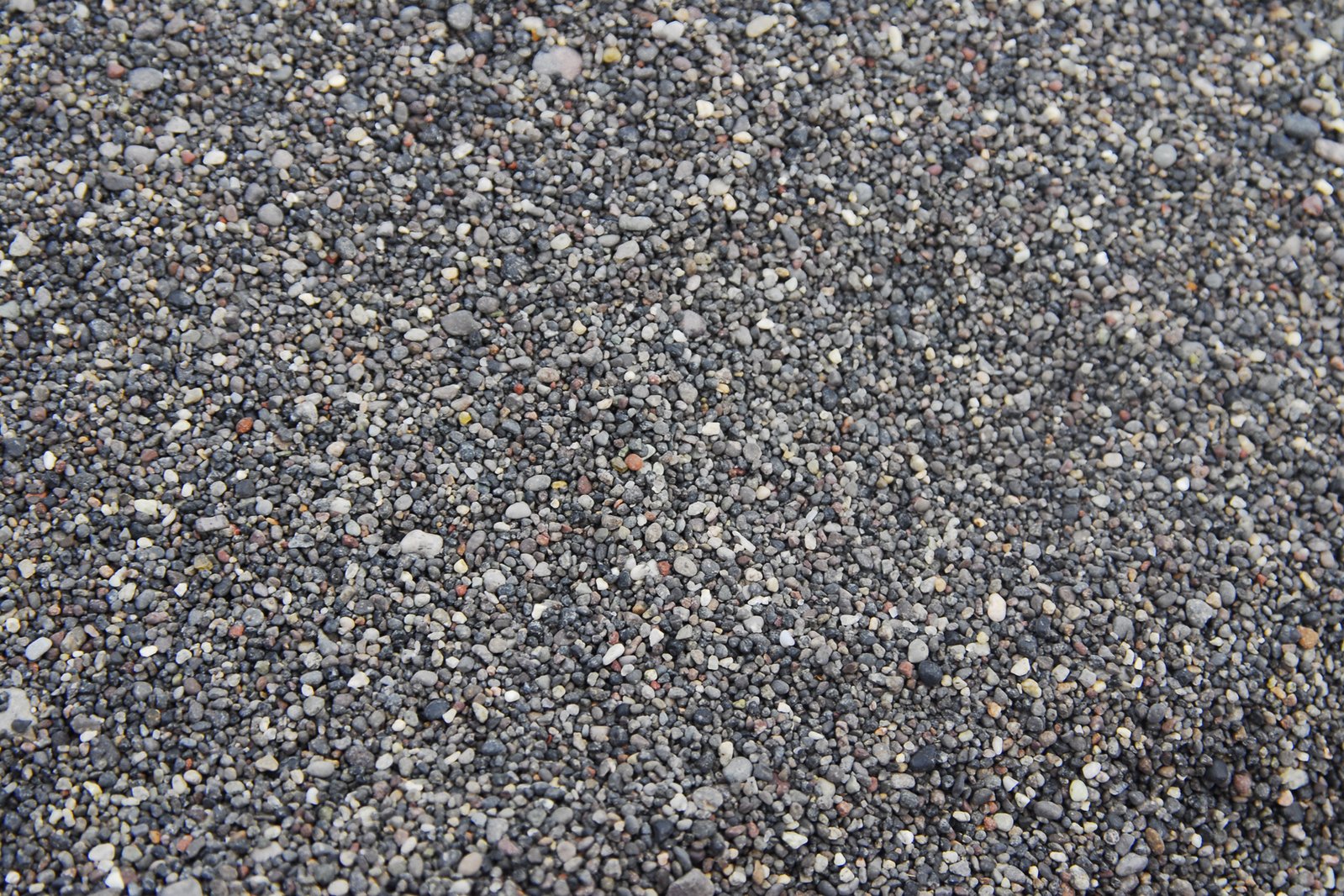 closeup of a gray stone surface with rocks and pebbles