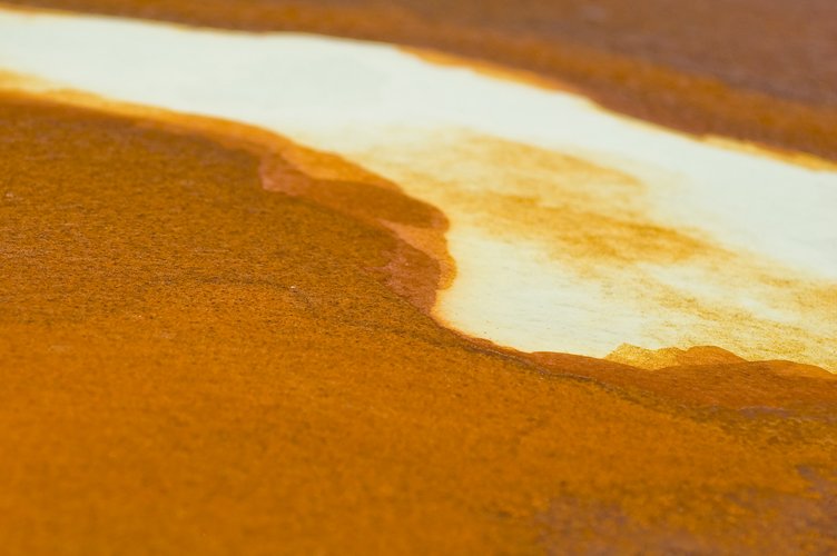 the sun reflects on the orange paint that is visible in the water