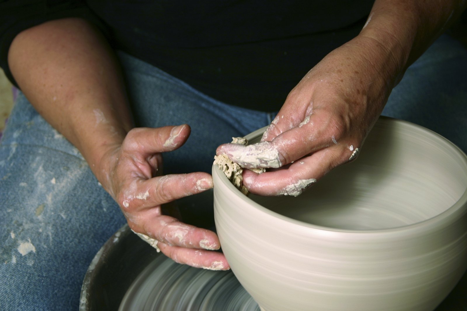 a person using a pottery wheel on it