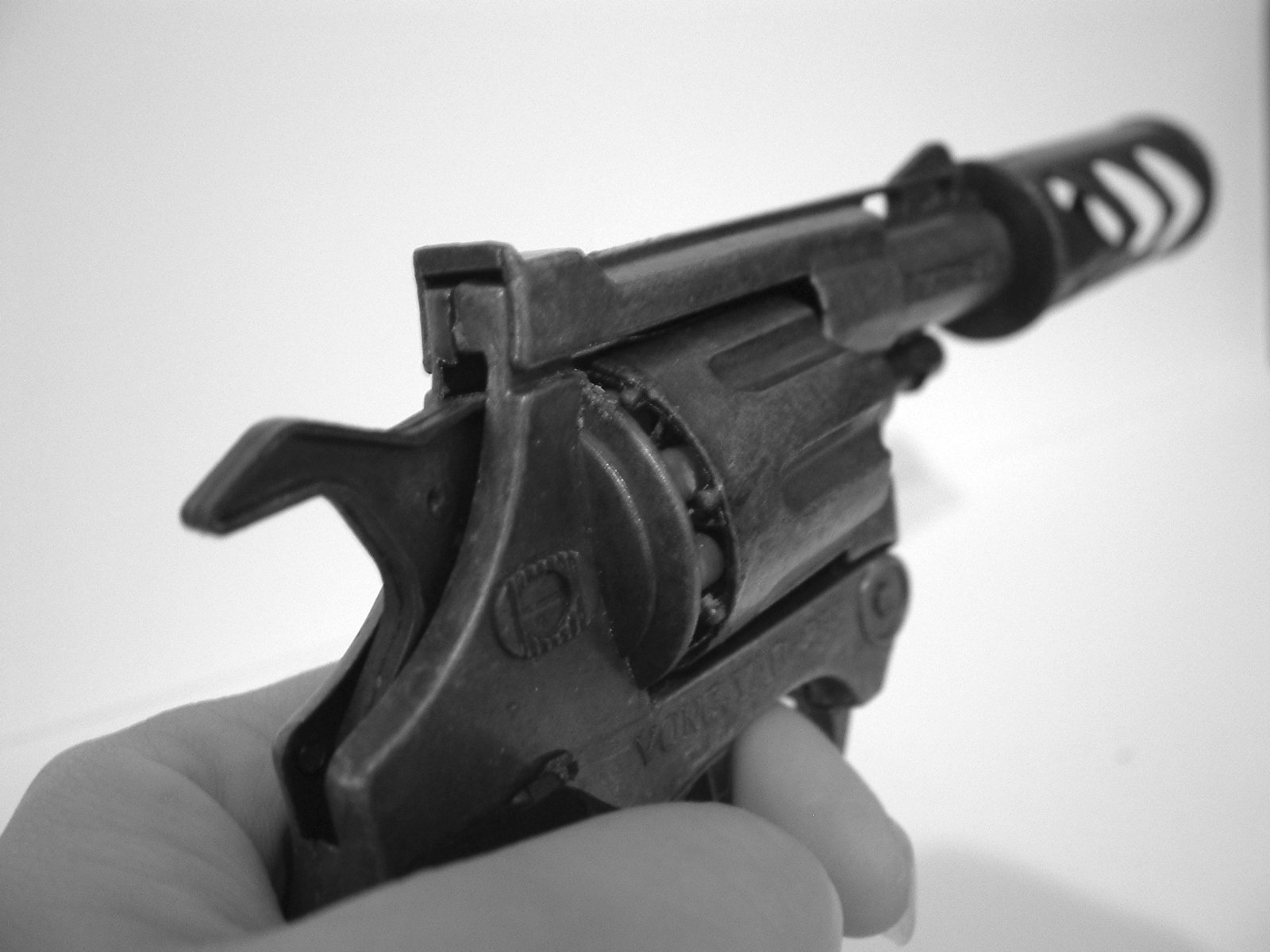 a person holding a small gun with some sort of attachment