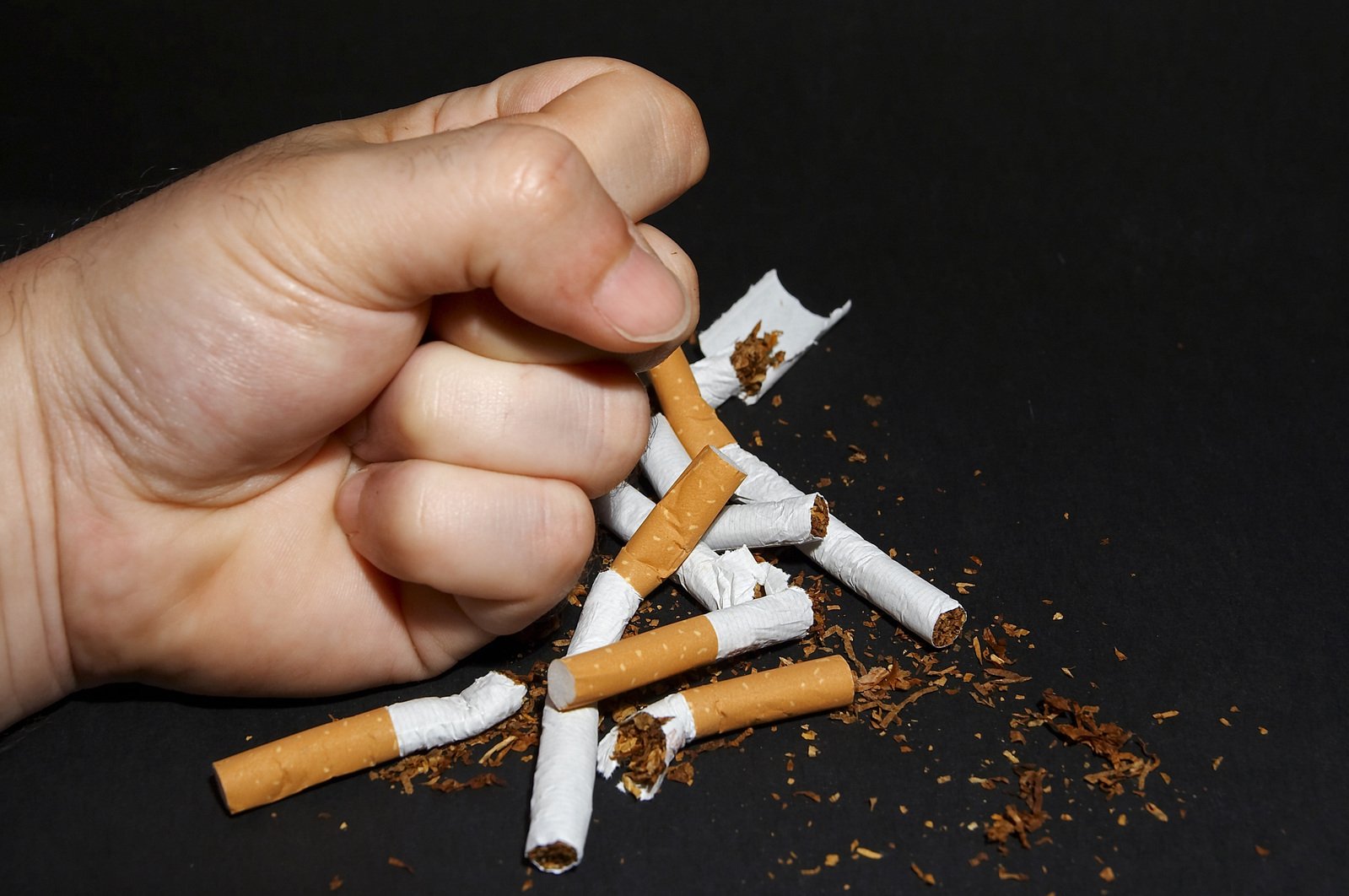 an unrecognized cigarette being held by a hand