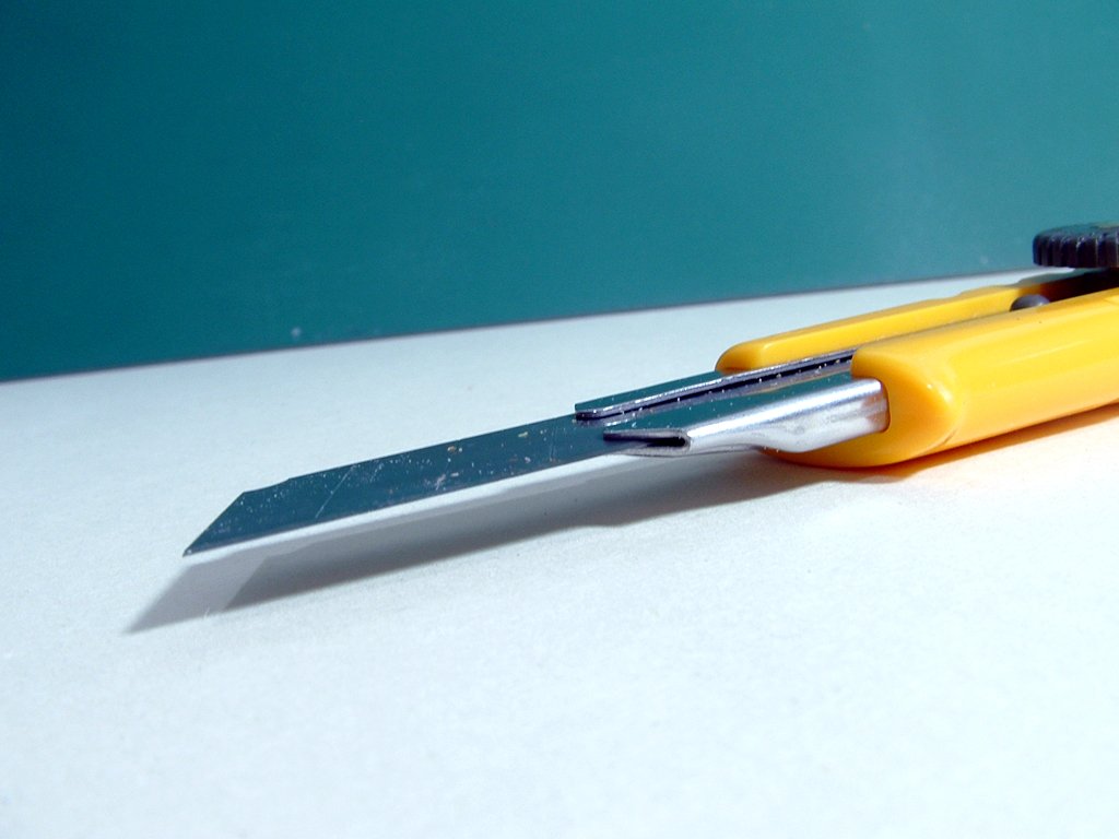 a pair of yellow handled scissors next to each other
