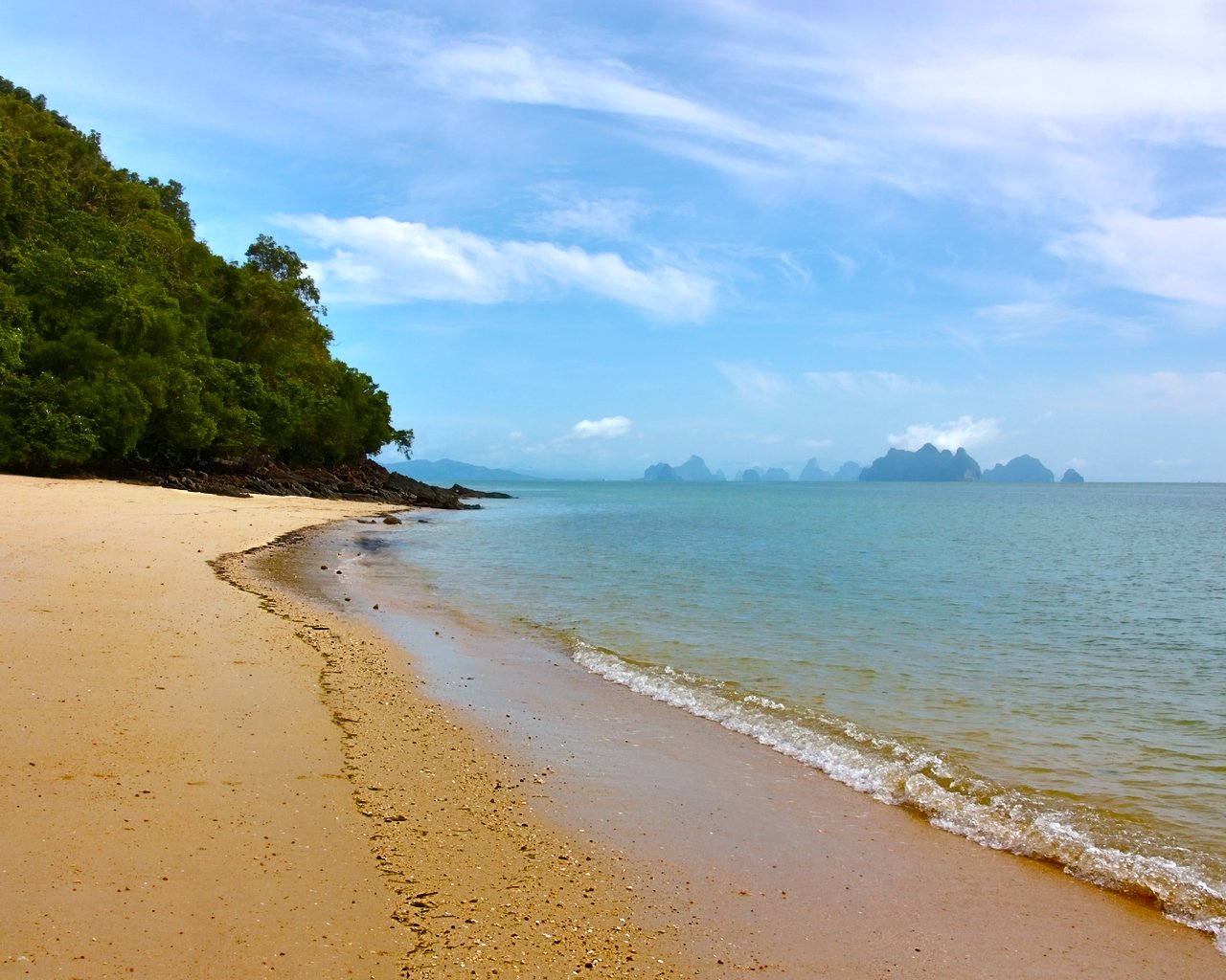 a sandy beach with a large body of water