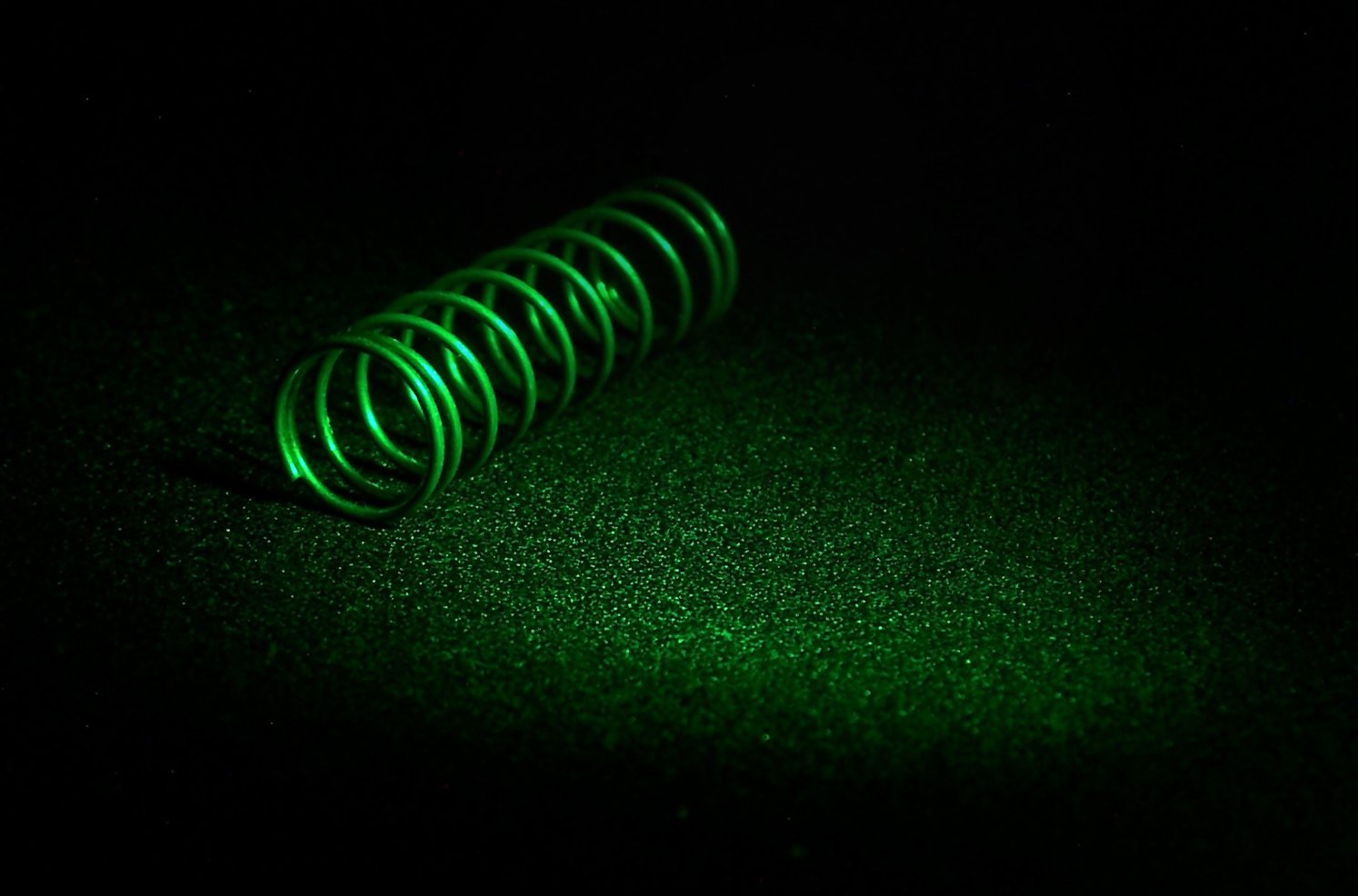 a glowing neon green spiral or spring