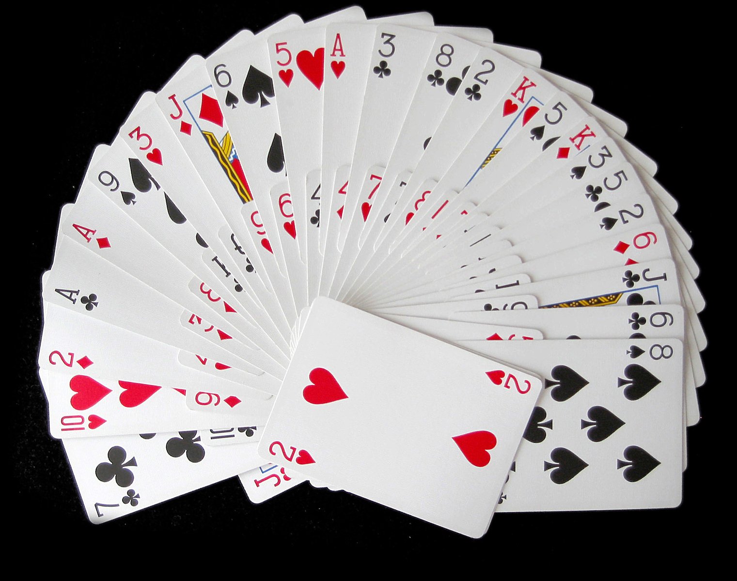 the set of poker cards on a black surface