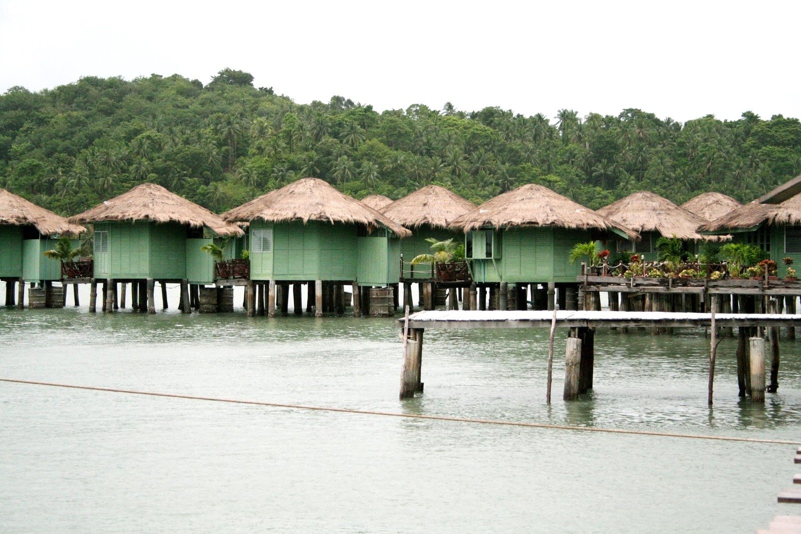 a number of huts on stilts near water