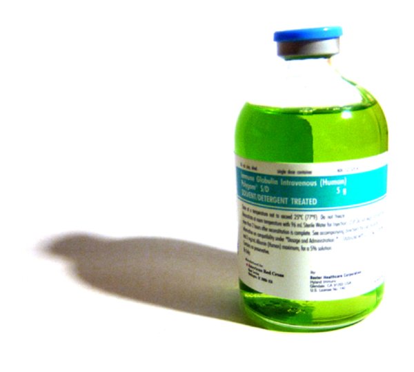 green liquid bottle containing alcohol sitting on top of a white floor
