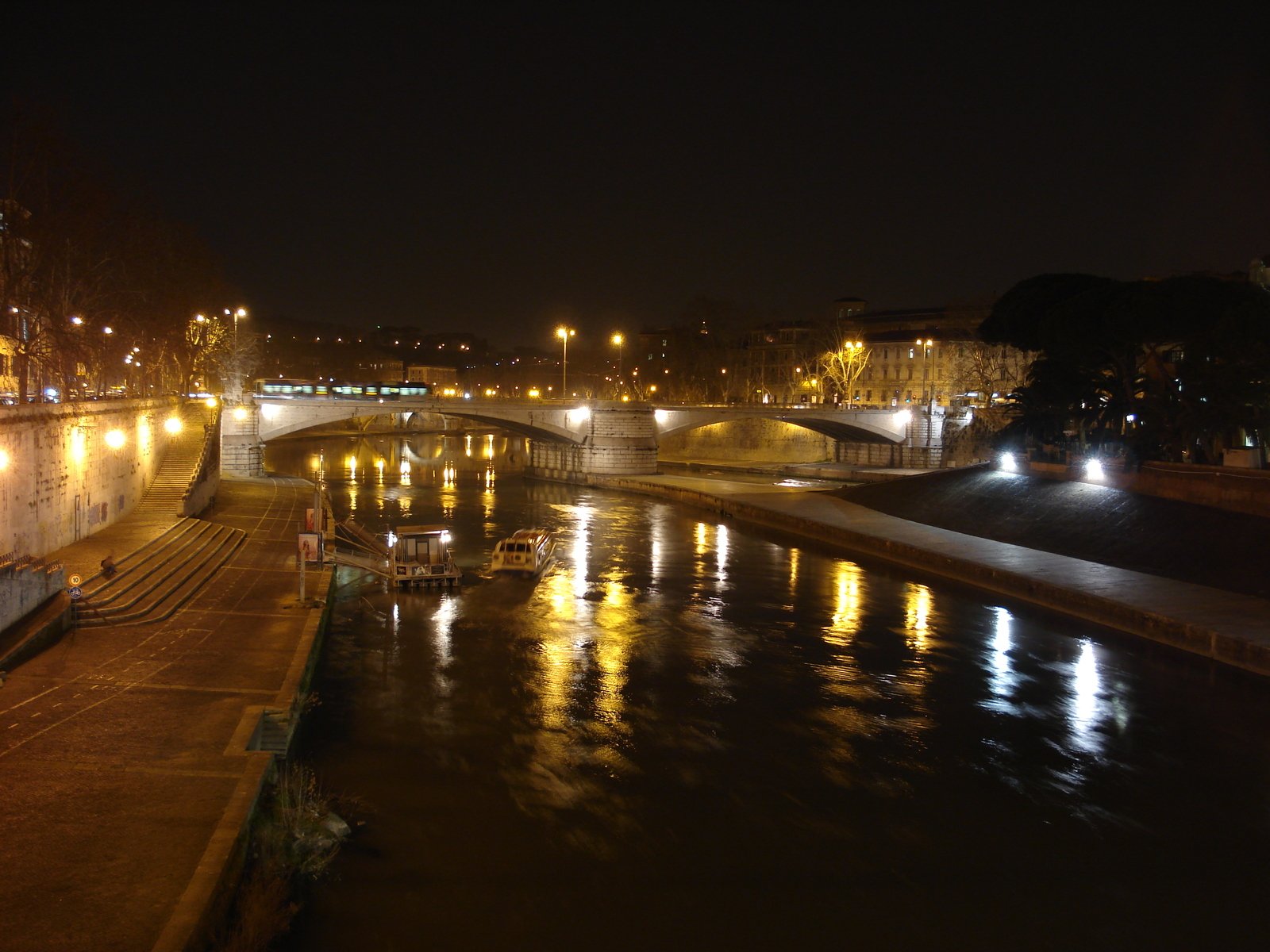 a bridge over water with lights on at night