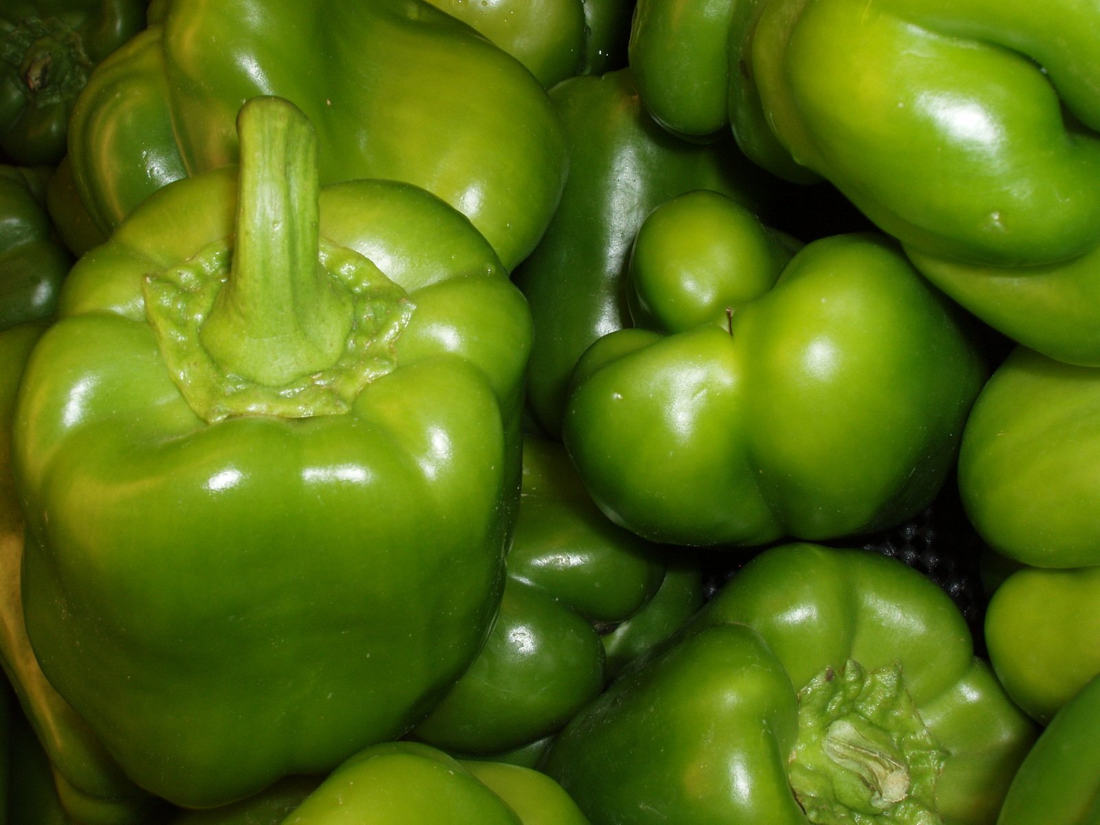 green peppers sit piled next to each other