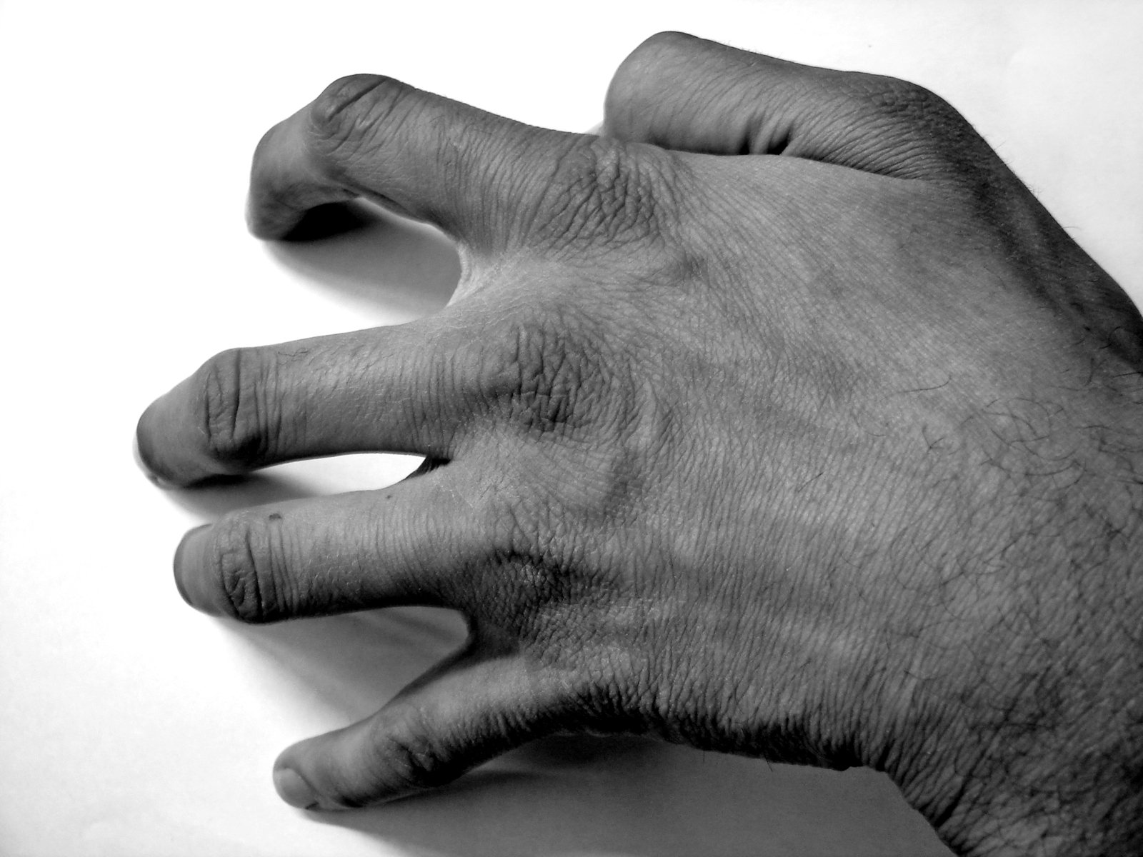a black and white po of someones hand with the thumb down