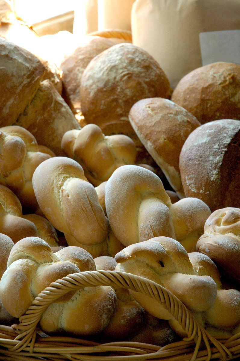 bread rolls and rolls are displayed in baskets