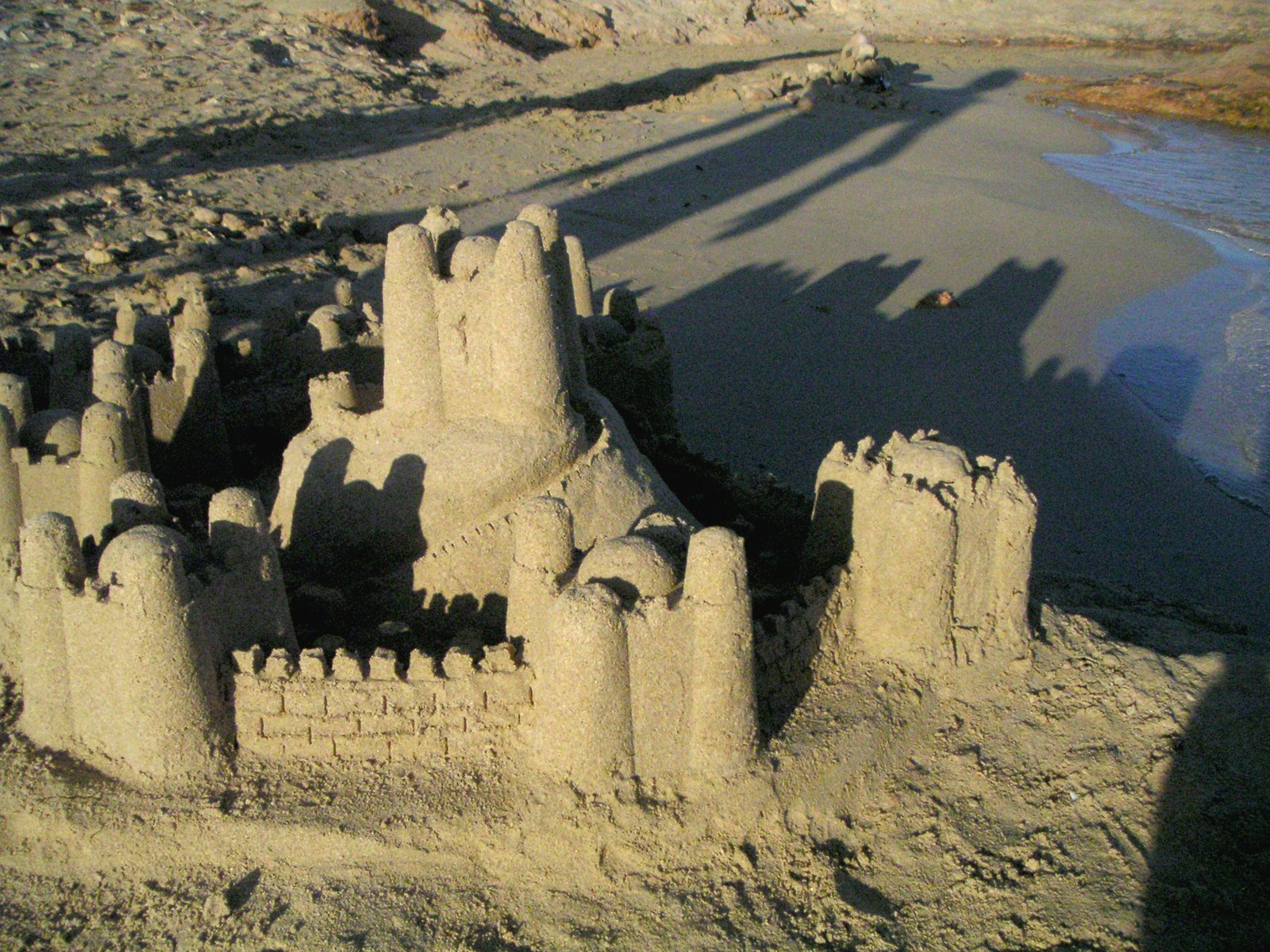 an elaborate castle made of sand on a beach