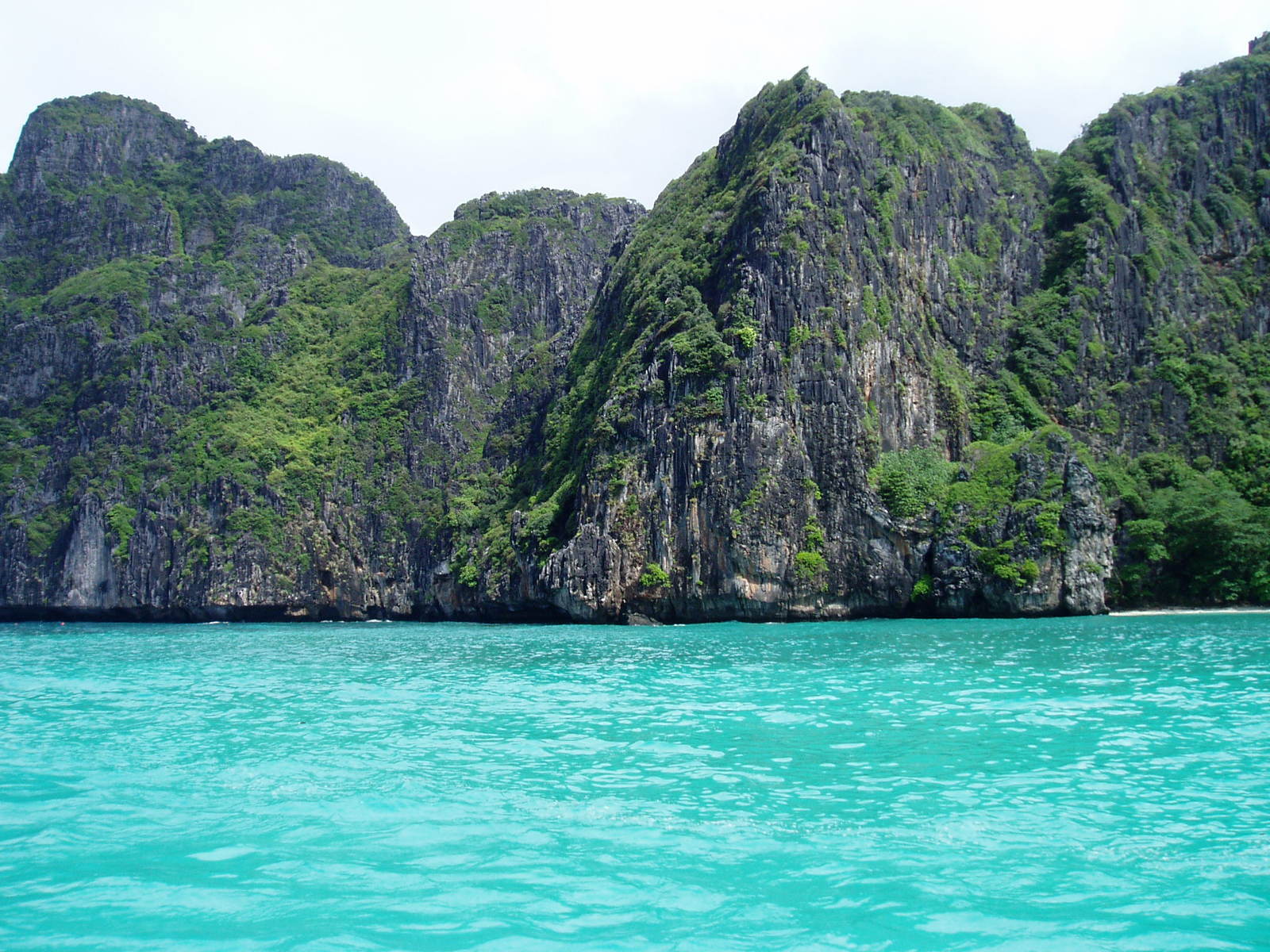 a group of small cliffs in a bay between two smaller mountains