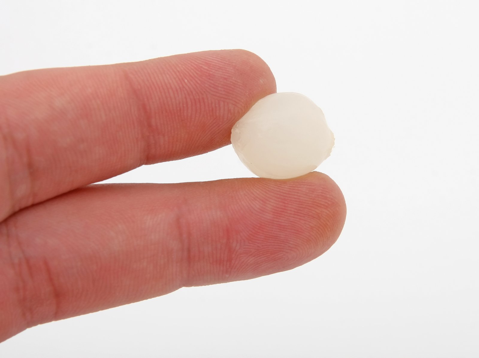 a small ball of white stuff being held by someone's hand
