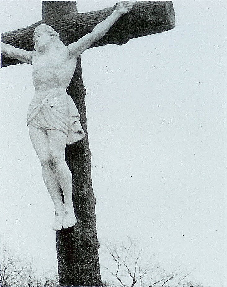 the statue is on top of the cross