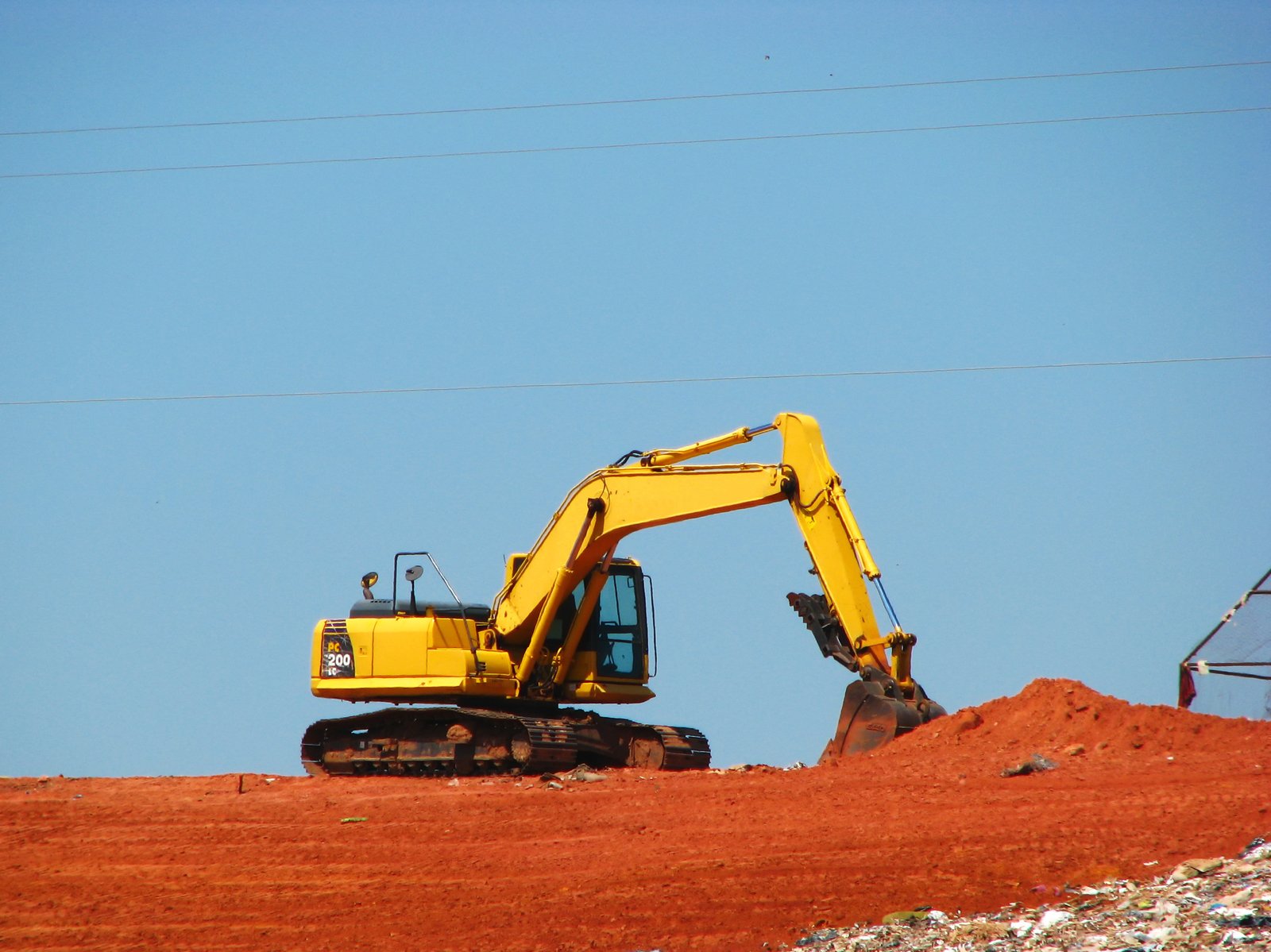 there is an industrial machine that is digging the land