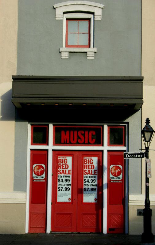 a store front with red doors and banners on the windows