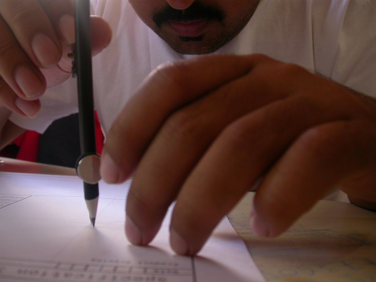 man looking through papers with scissors in his hands