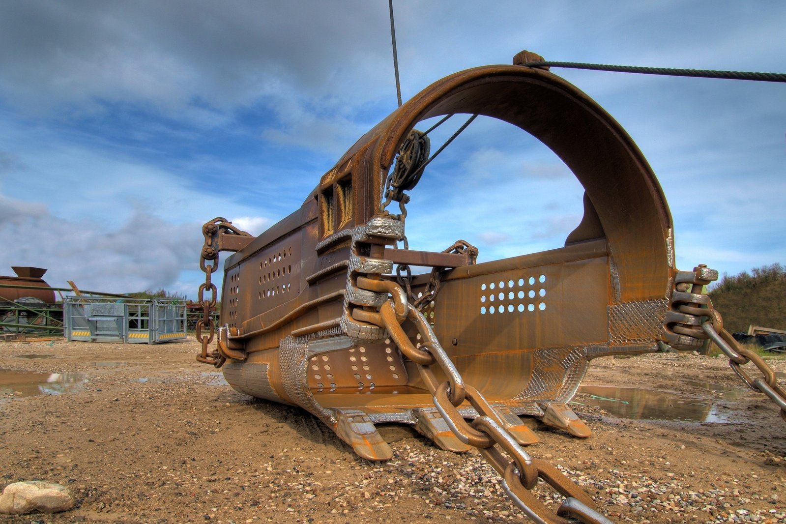 a rusted out old tractor laying on top of some dirt