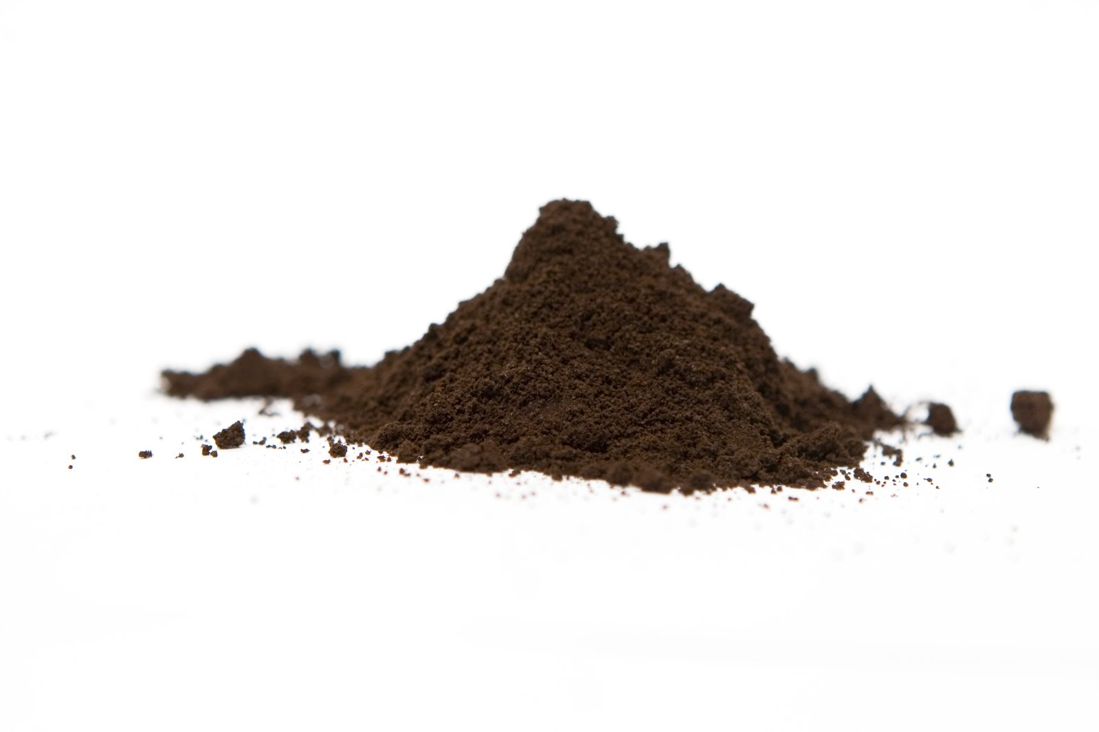 a pile of dirt sitting on top of a white ground