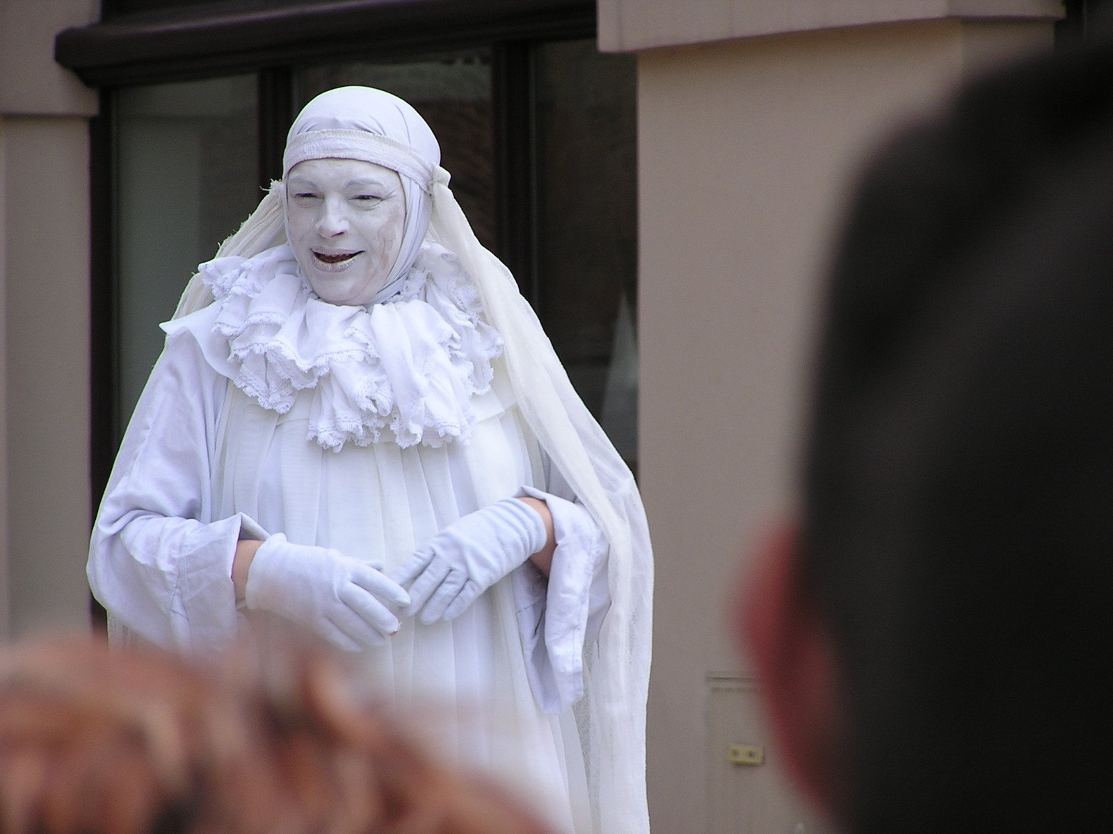 a creepy man dressed in white wearing white