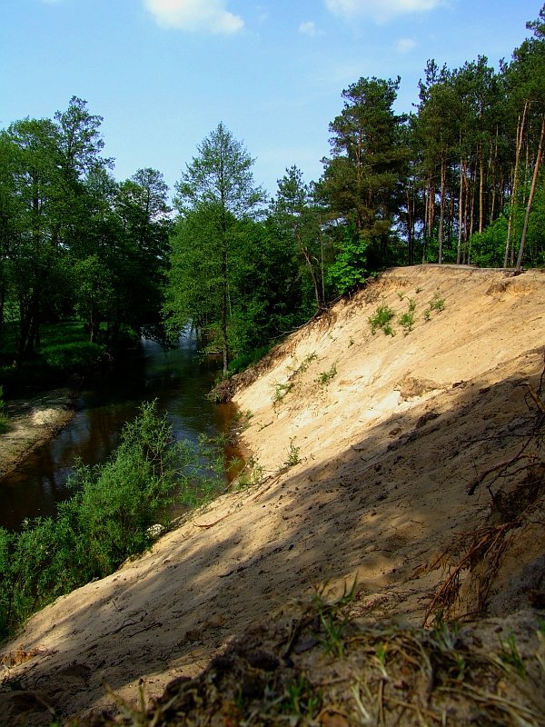 a rocky hill with a small stream running up the side