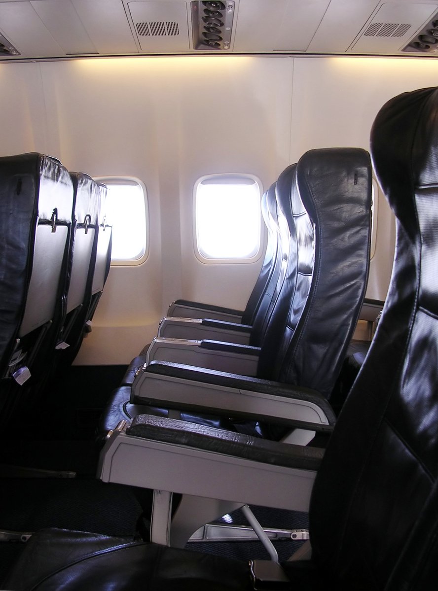 some seats in the back area of an airplane