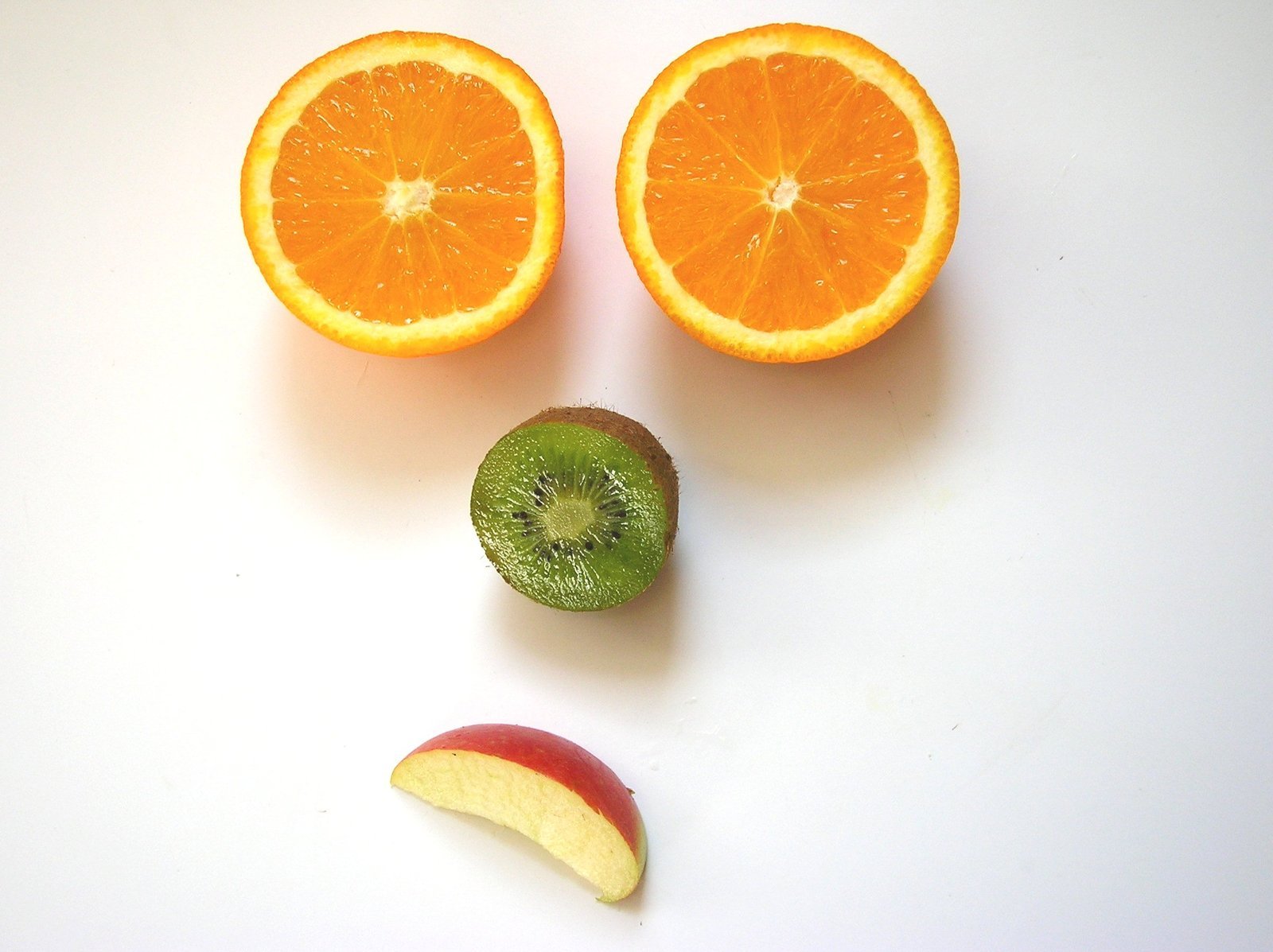 two pieces of fruit with eyes made of each other