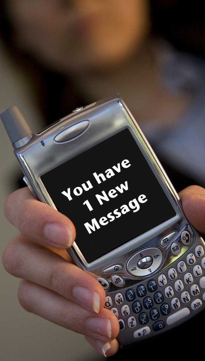 a person holding a cell phone that says you have i now message