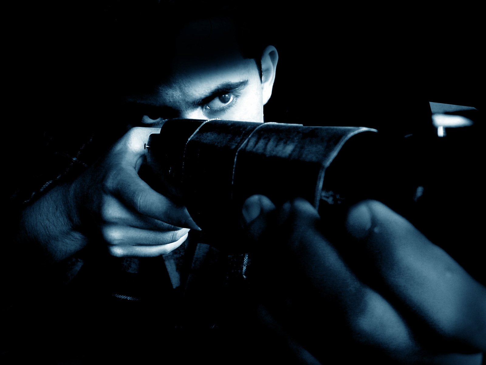 a person looking through the telescope with one hand and holding soing else