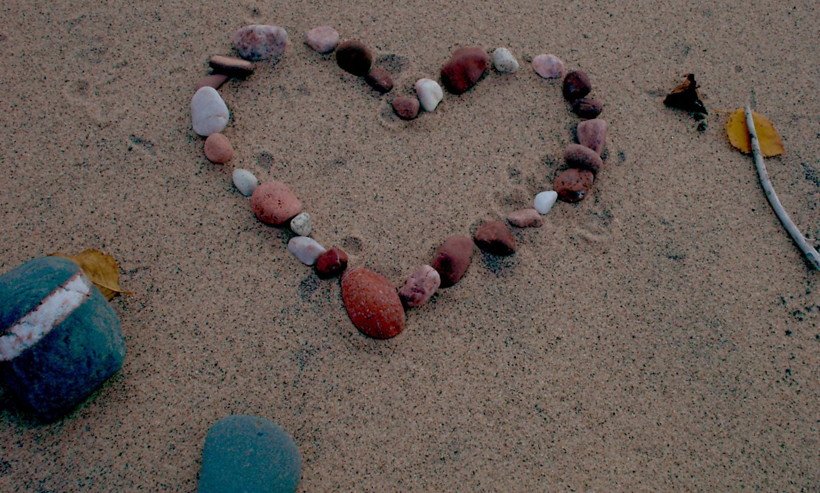 the word love spelled out in the sand and various types of shells