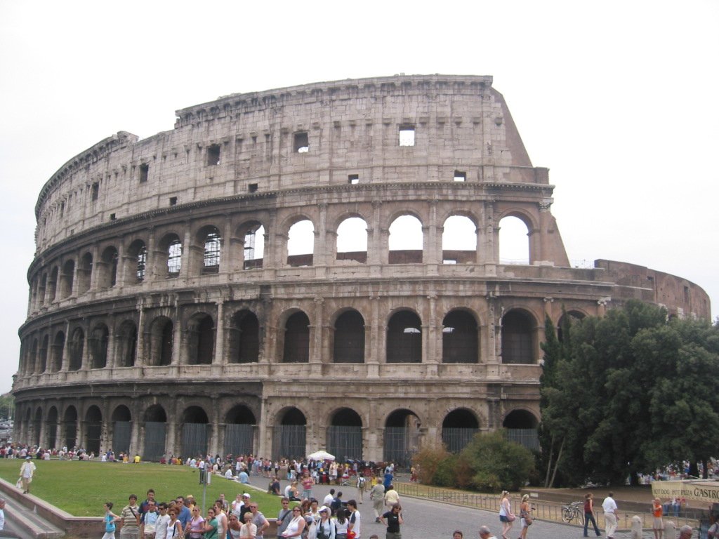 some people are gathered around and outside an old building