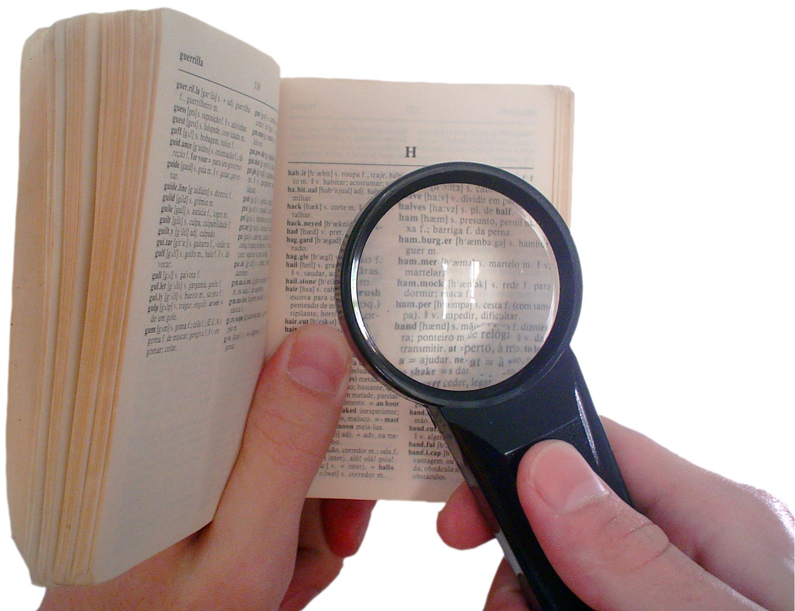 a person reading a book while holding a magnifying glass