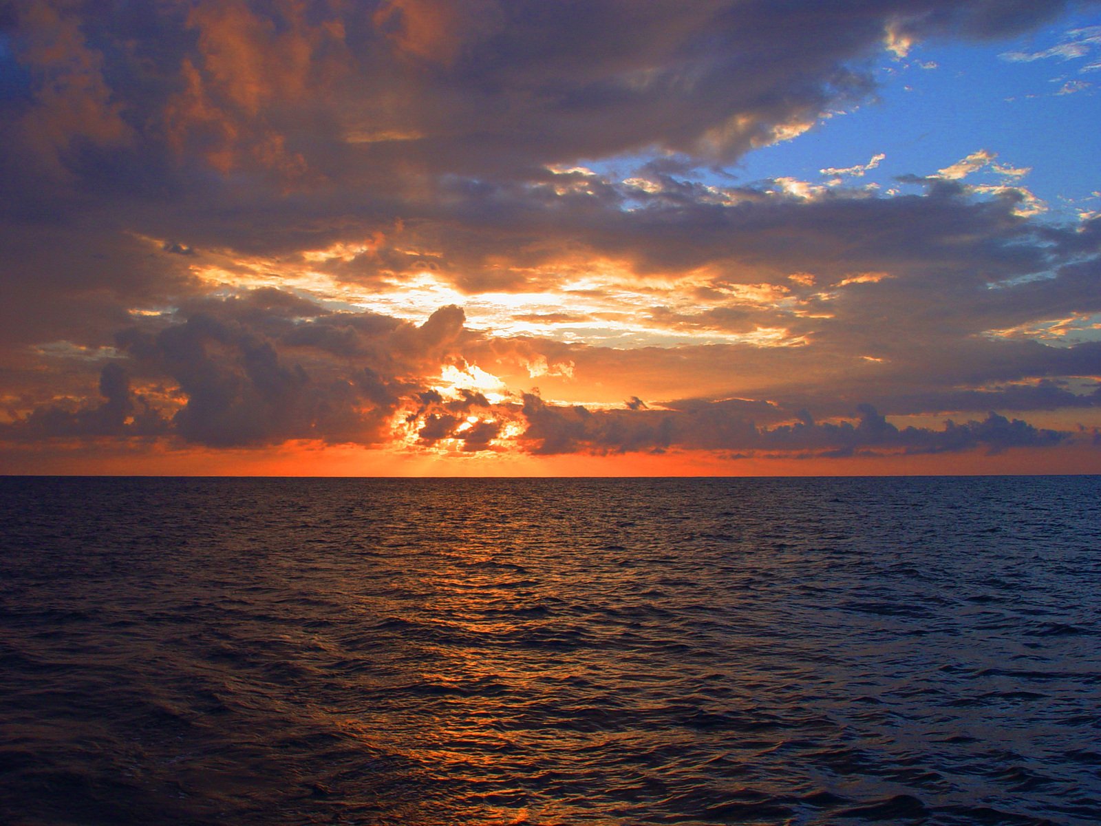 a large body of water at sunset