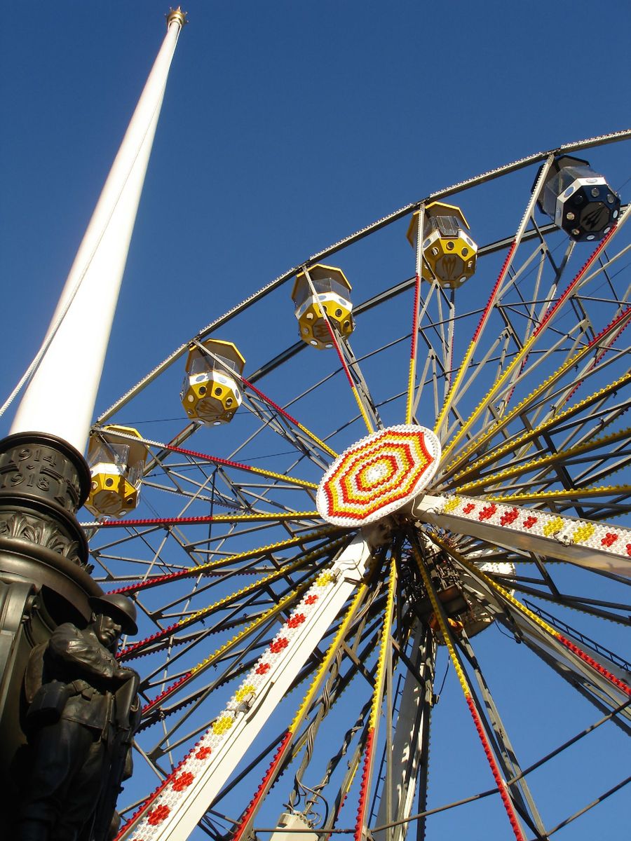 an empty ferris wheel against a blue sky