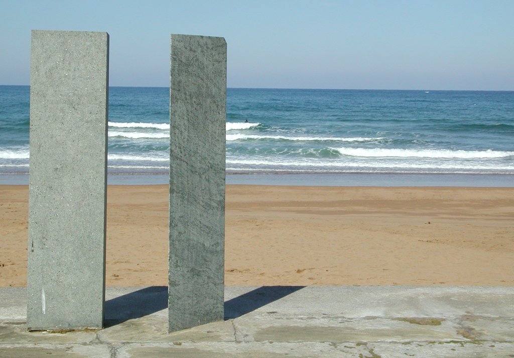 two long concrete slabs next to the ocean