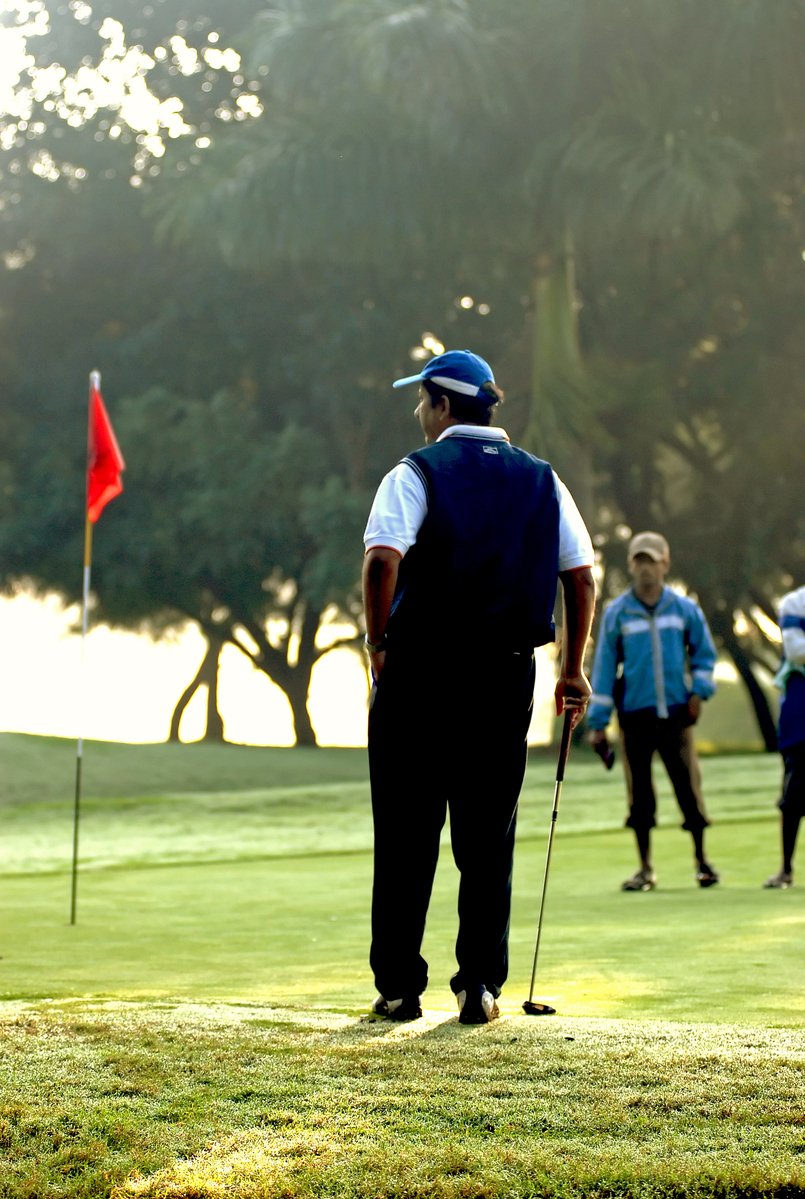 the golf players are playing on the course