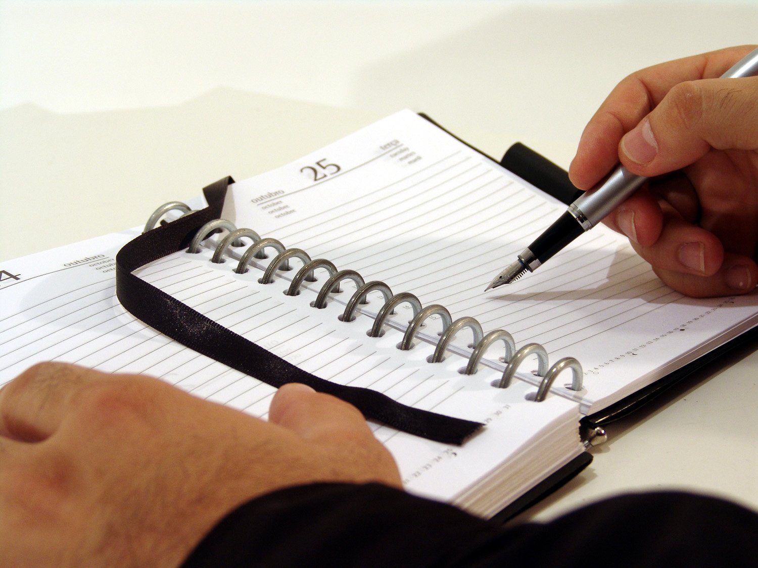 a man writing on an exercise bind with his hand