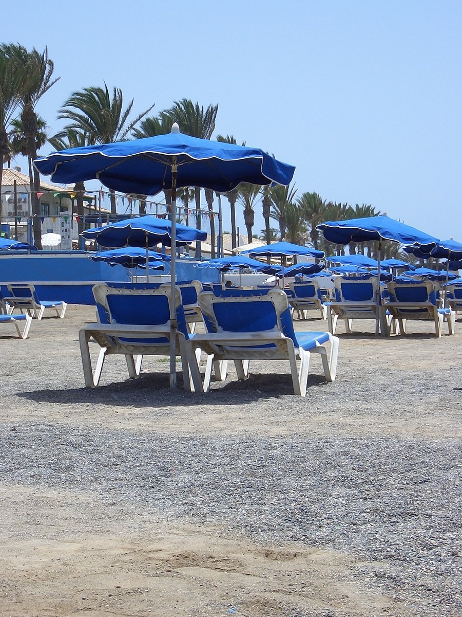 chairs are set up on the beach for the guests