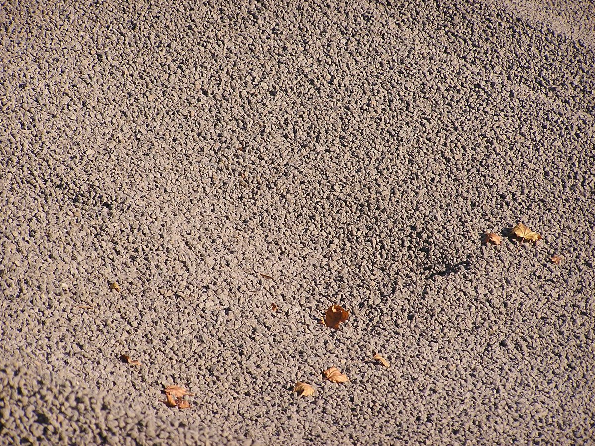 a view of sand with several small pieces of food sticking out