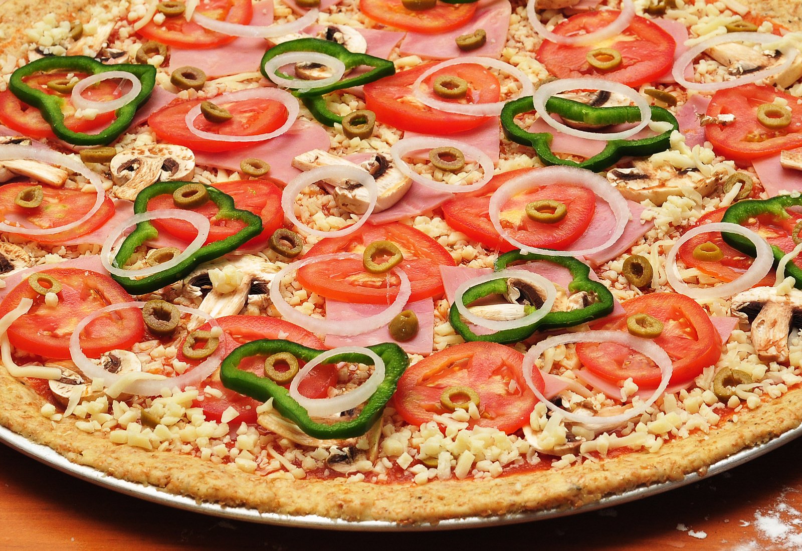 this pizza has cheese, onions, and tomatoes on top