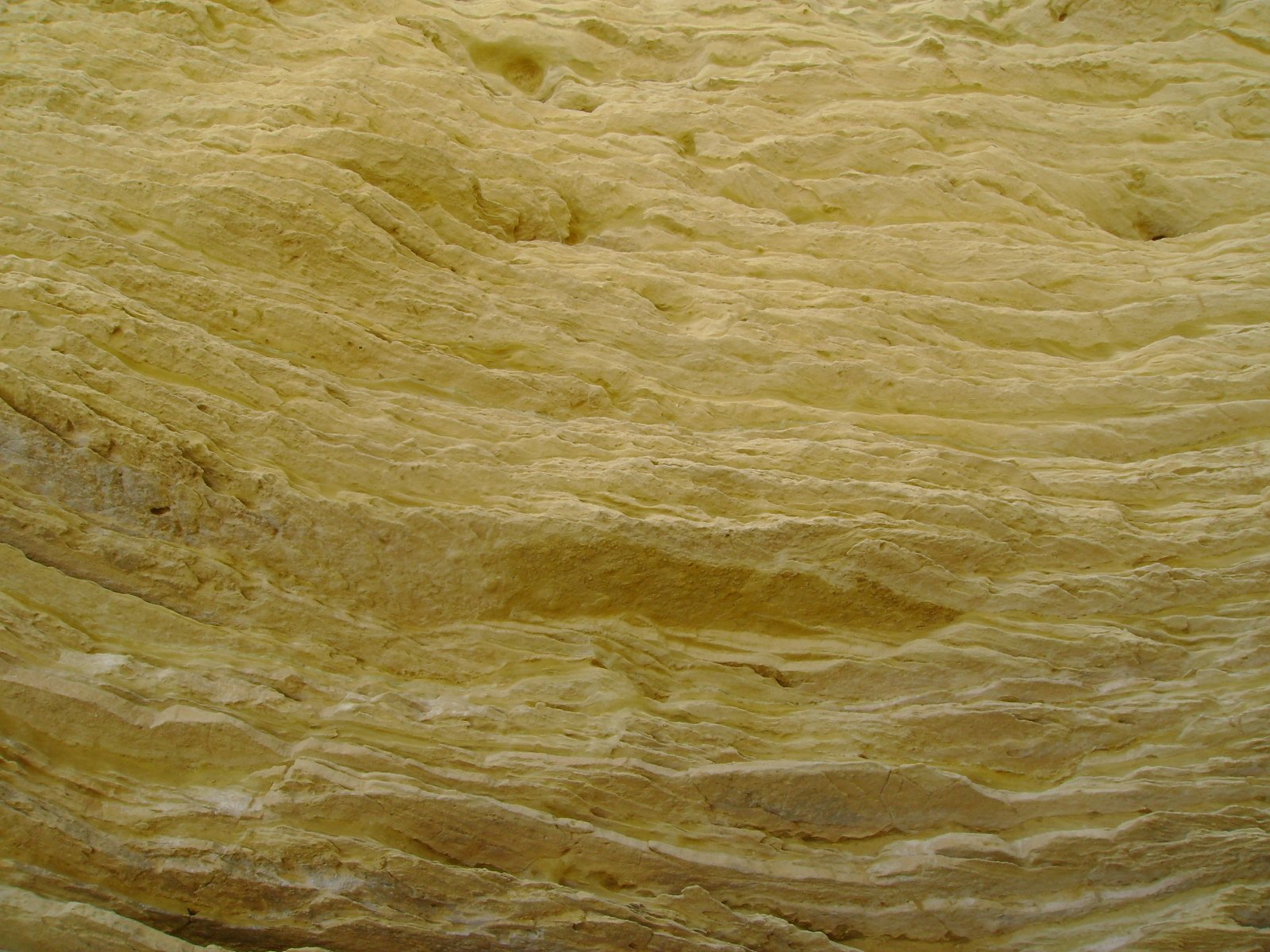 yellow rock formation with very little visible s