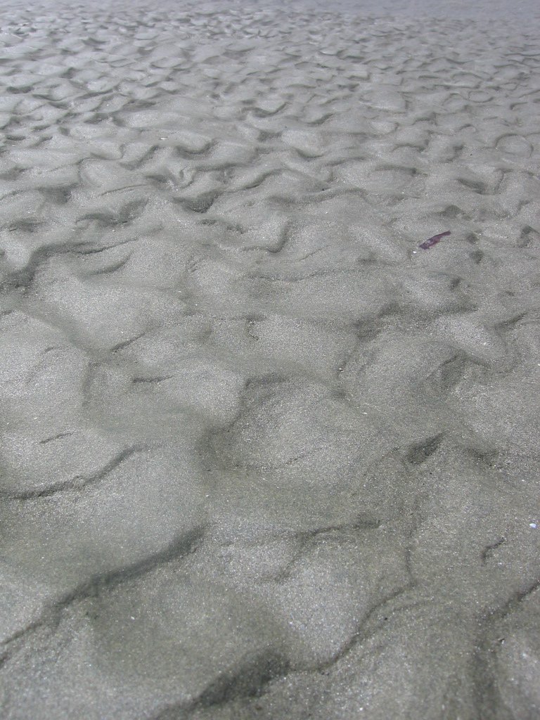 the surface of a beach covered in snow