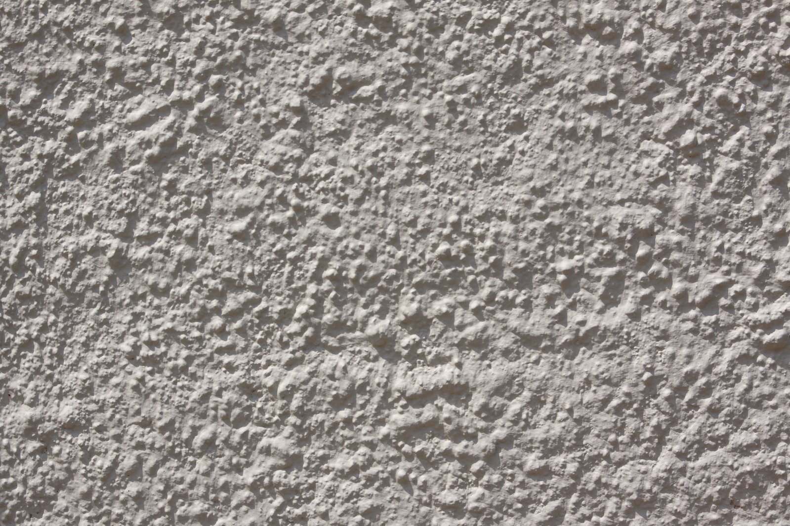 the texture of a stucco wall that has been painted white