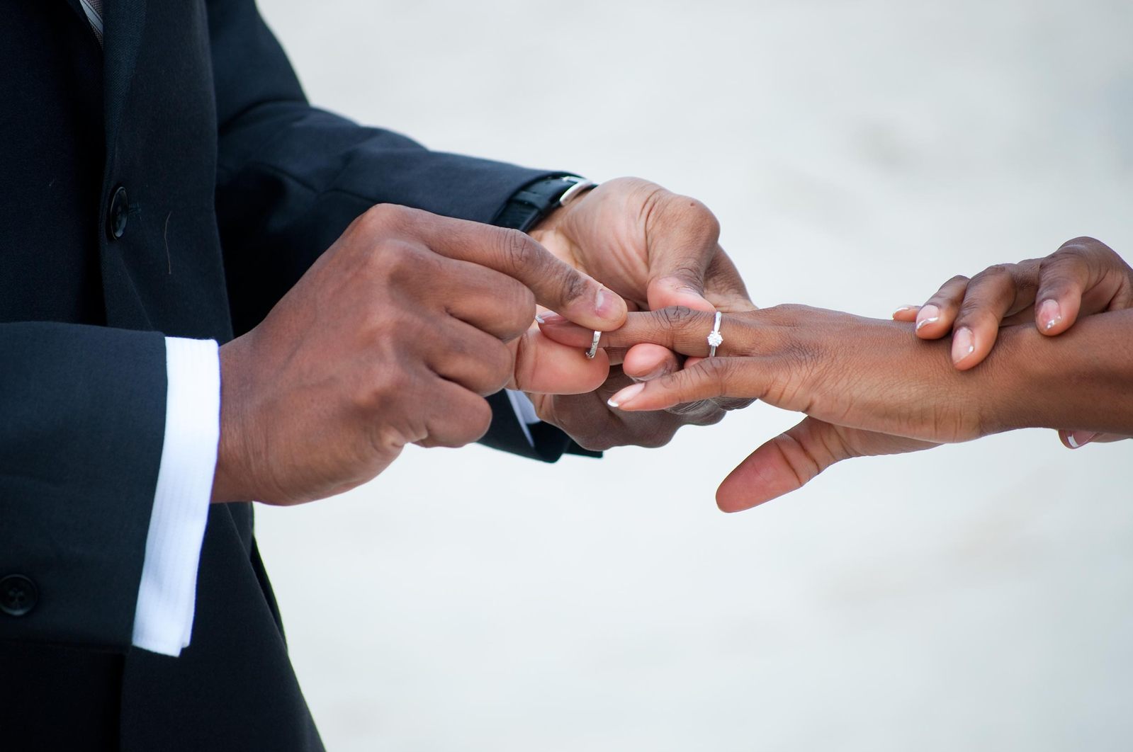 two people putting their hands together in a wreath