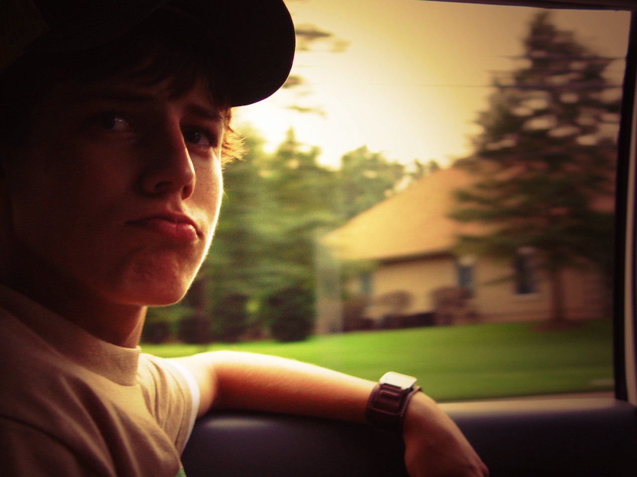 a person sitting behind the wheel of a car in a field