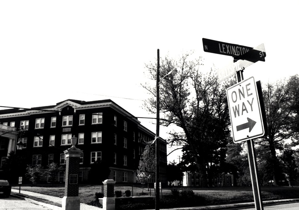 a street sign that is next to a parking sign