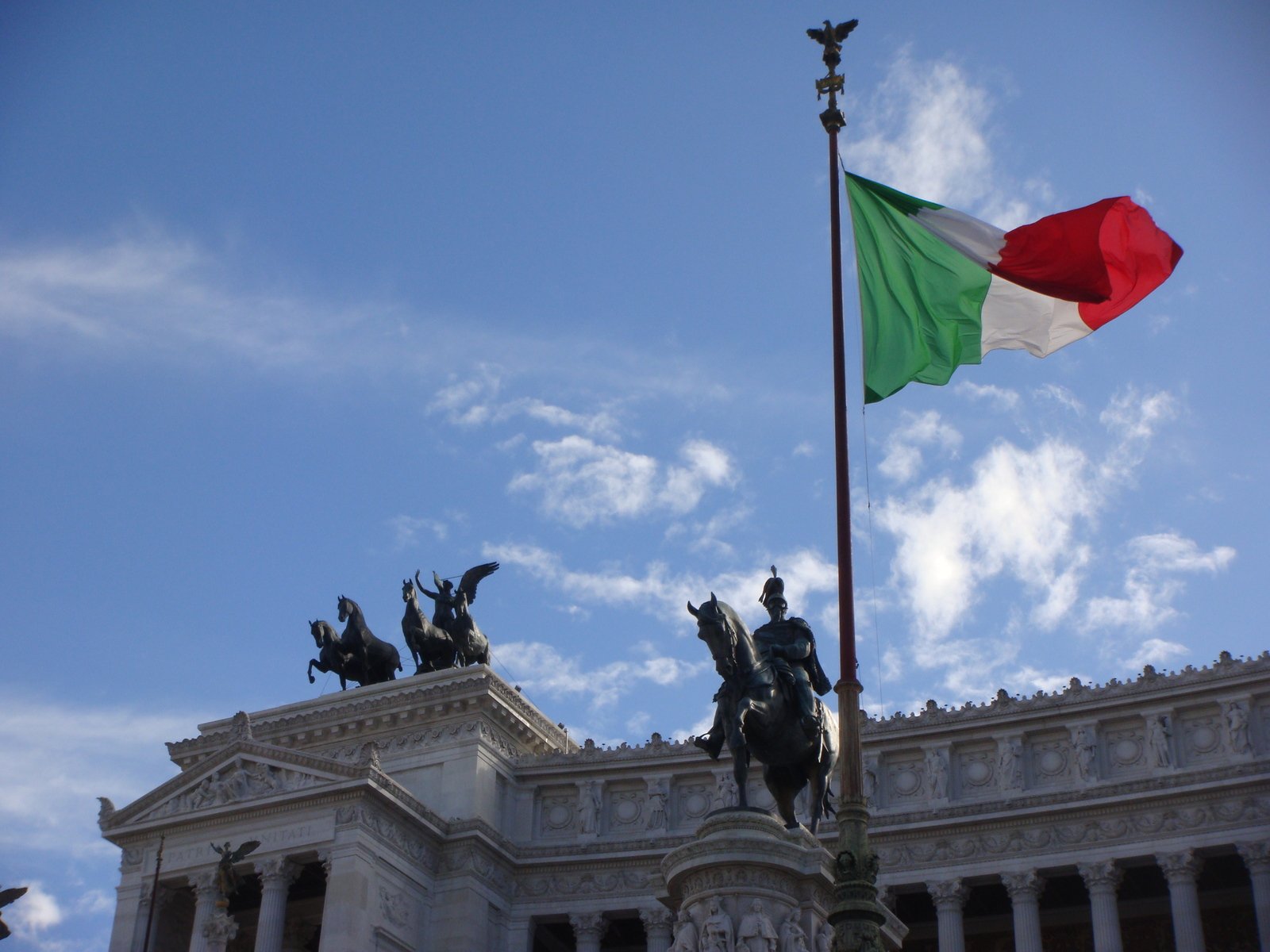 the flag has been flown in front of the equestrian statue of a city