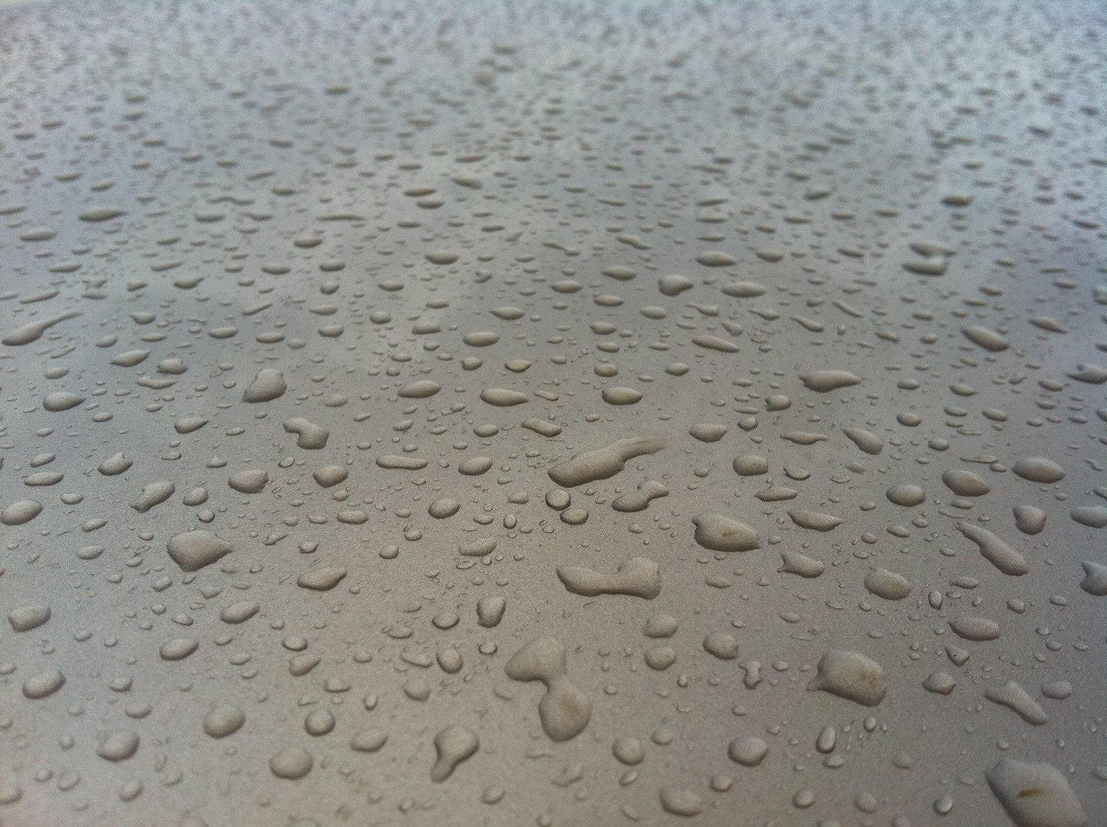 a bunch of drops on top of some sand