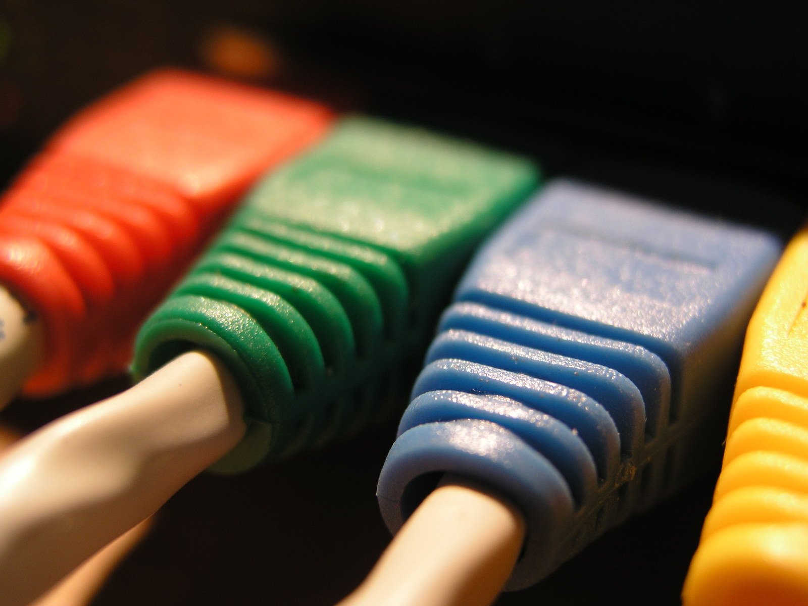a close up of four different colored wires